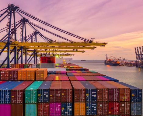 Container ship loading and unloading in deep sea port at sunset, Aerial view of business logistic import and  export freight  transportation by container ship in open sea.